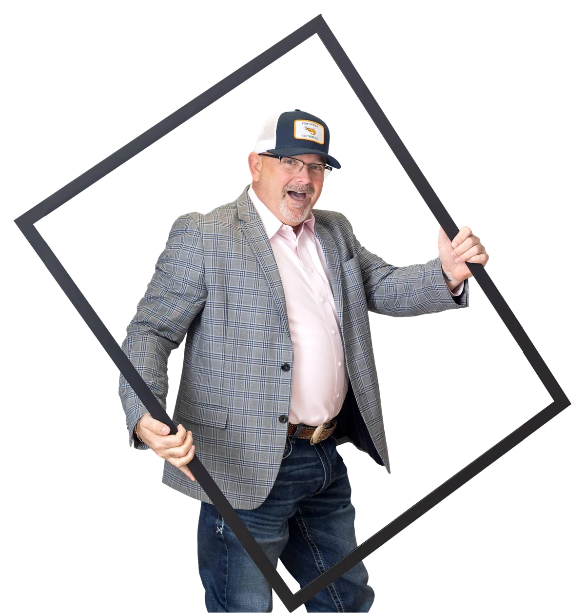 Coach Matt Kern, Denton business coach, laughing in a ball cap and plaid blazer as he leans through a large tilted picture frame.